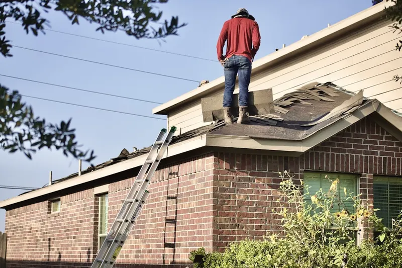 Professional roofer working on a residential roof in Spring Creek Forest